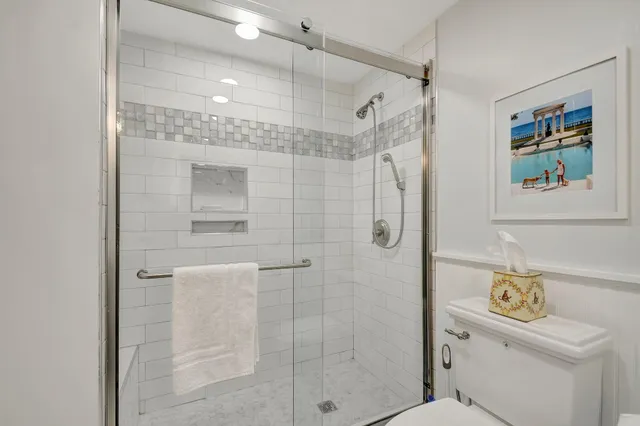 a bathroom with a sink mirror and a shower