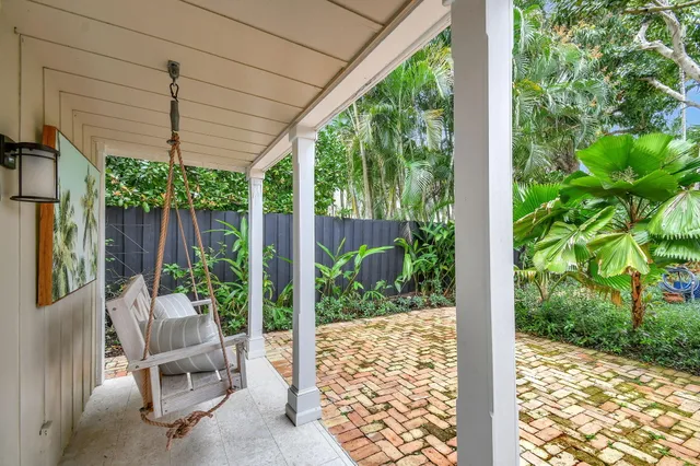 a balcony with furniture and garden view