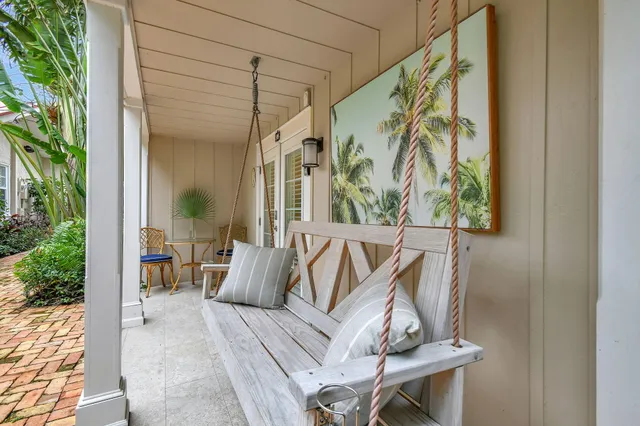a view of balcony with furniture and a potted plant
