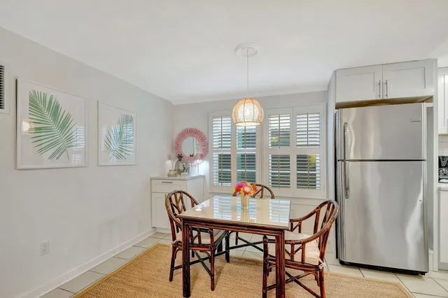 a view of a dining room with a table and chairs