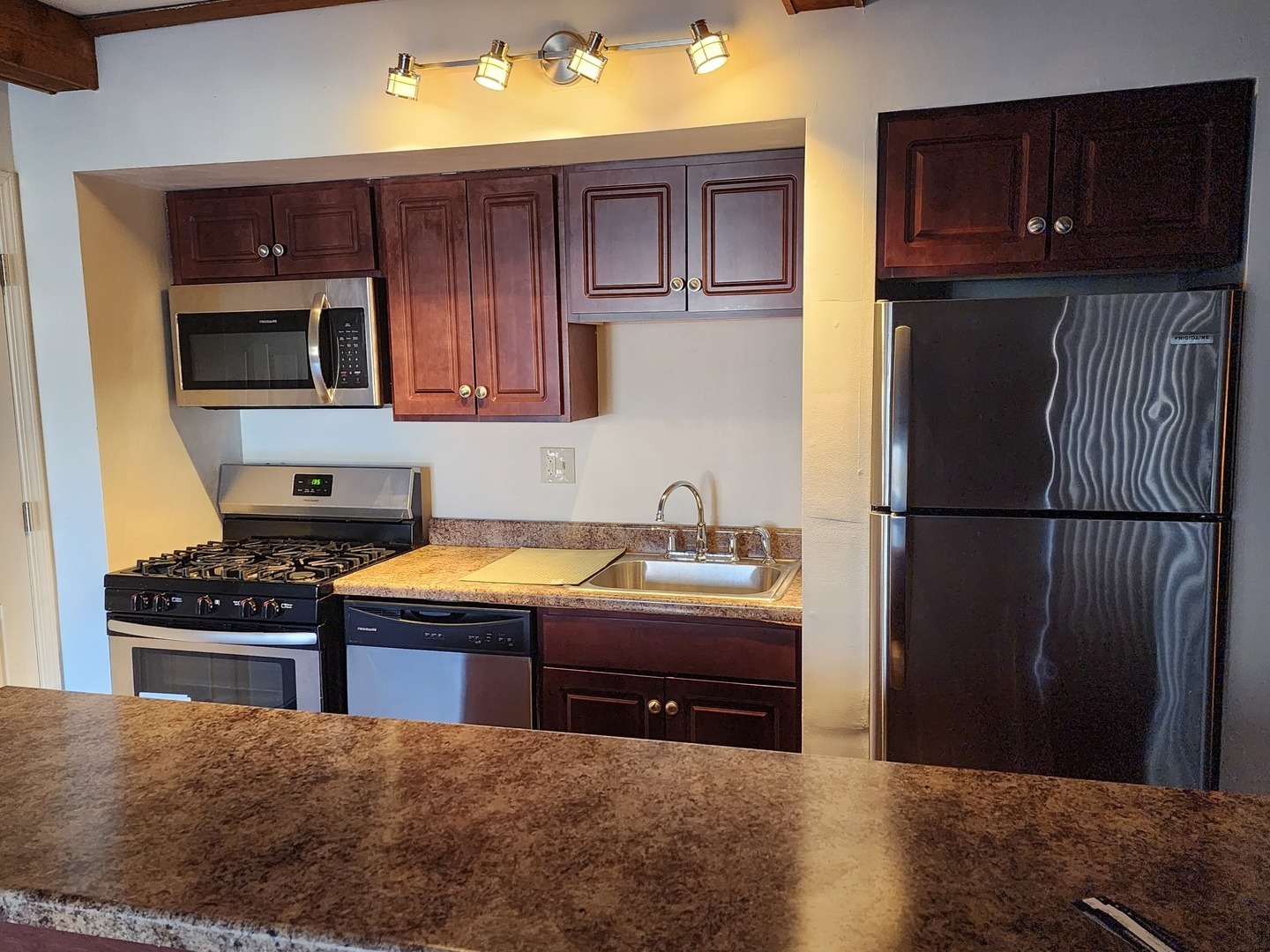 1503 Kenneth Circle Elgin, IL 60120 - Photo 8 of 18 a kitchen with granite countertop stainless steel appliances and wooden cabinets