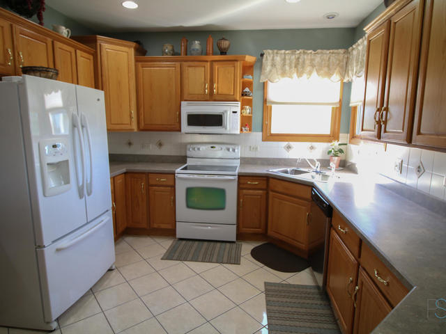 3617 East 1759th Road Ottawa, IL 61350 - Photo 7 of 20 a kitchen with a sink refrigerator and cabinets