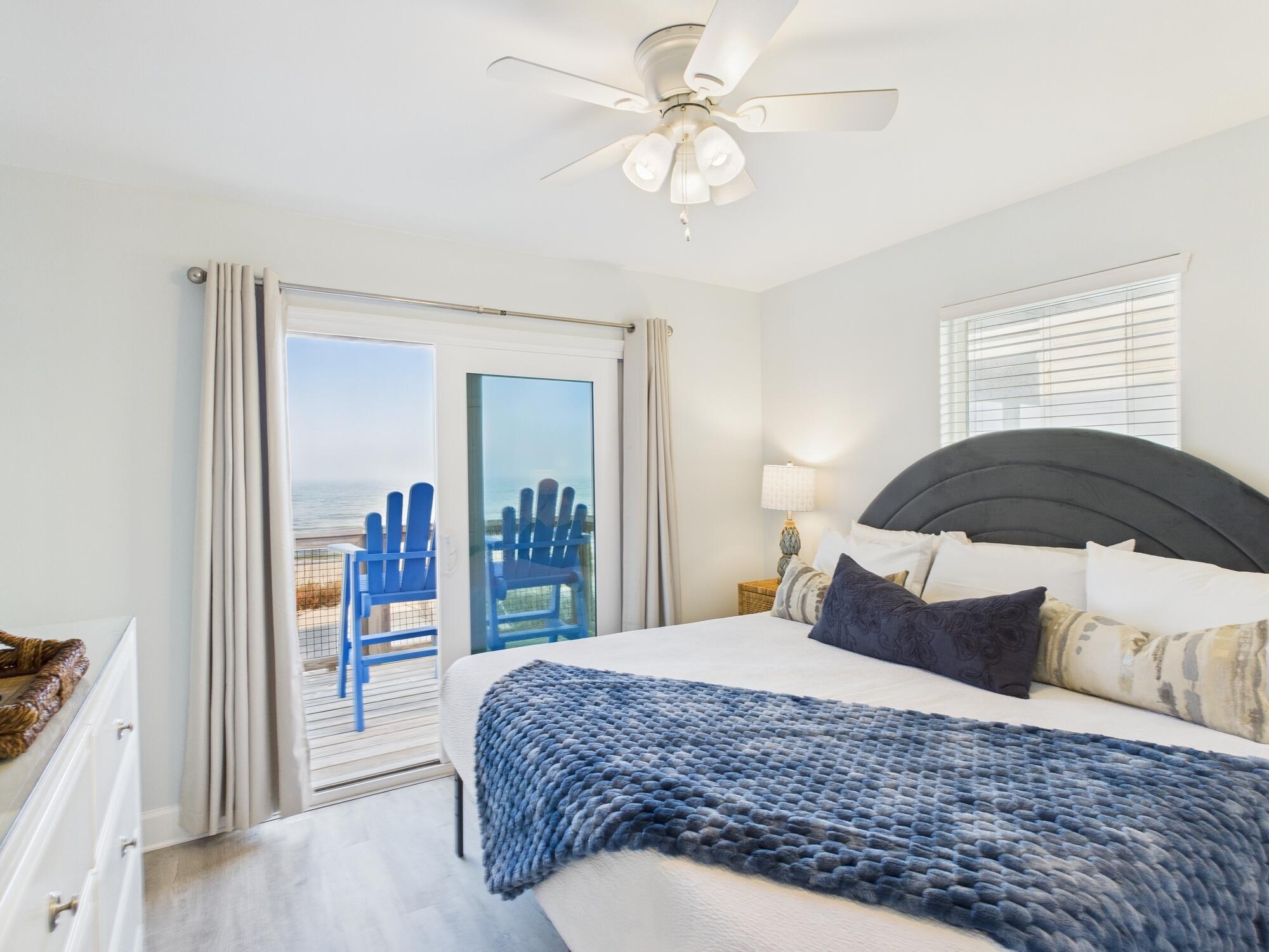 5191 Clipper Way Port St. Joe, FL 32456 - Photo 11 of 23 a bedroom with a large bed and a chandelier