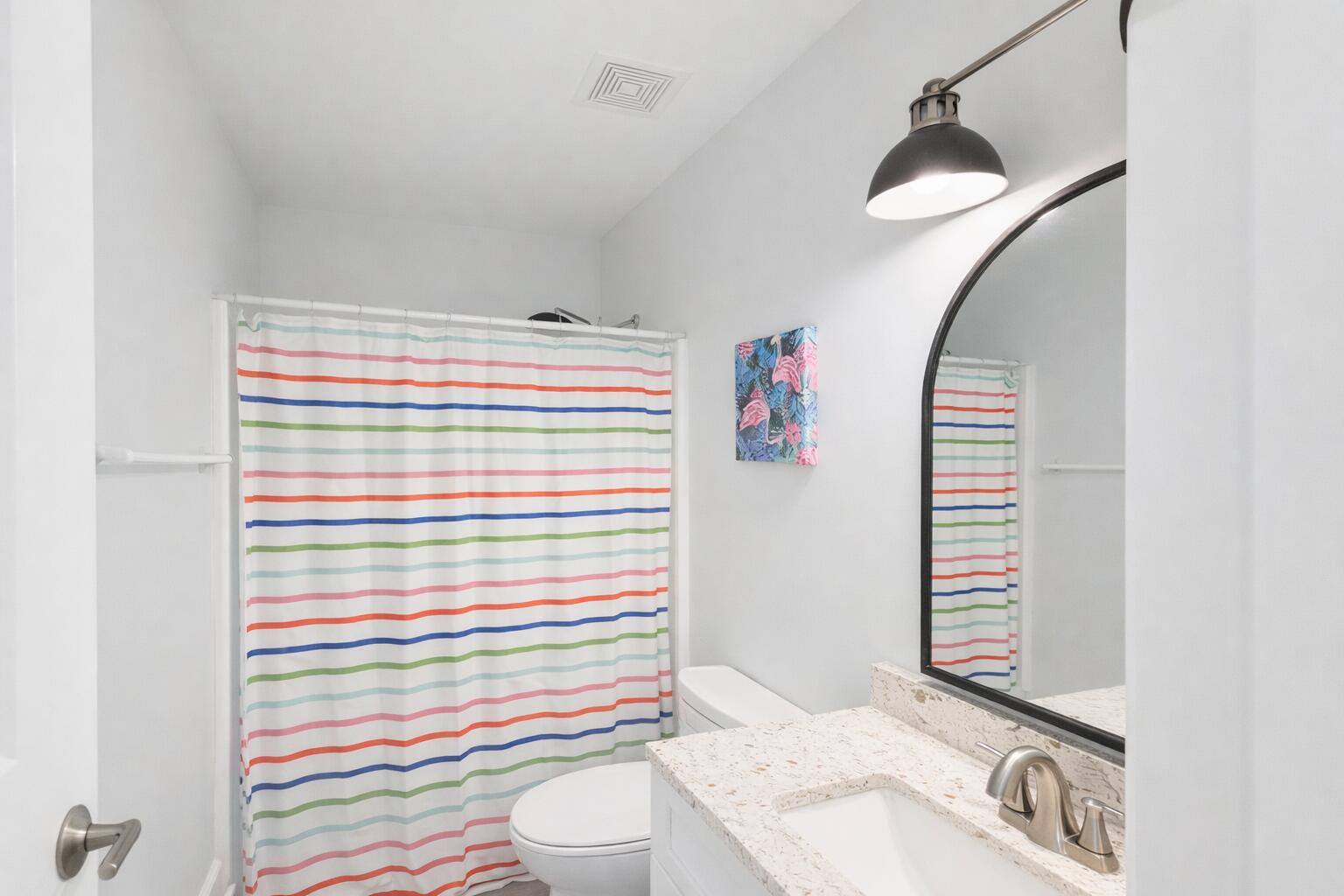 5191 Clipper Way Port St. Joe, FL 32456 - Photo 17 of 23 a bathroom with a sink a toilet and shower curtain