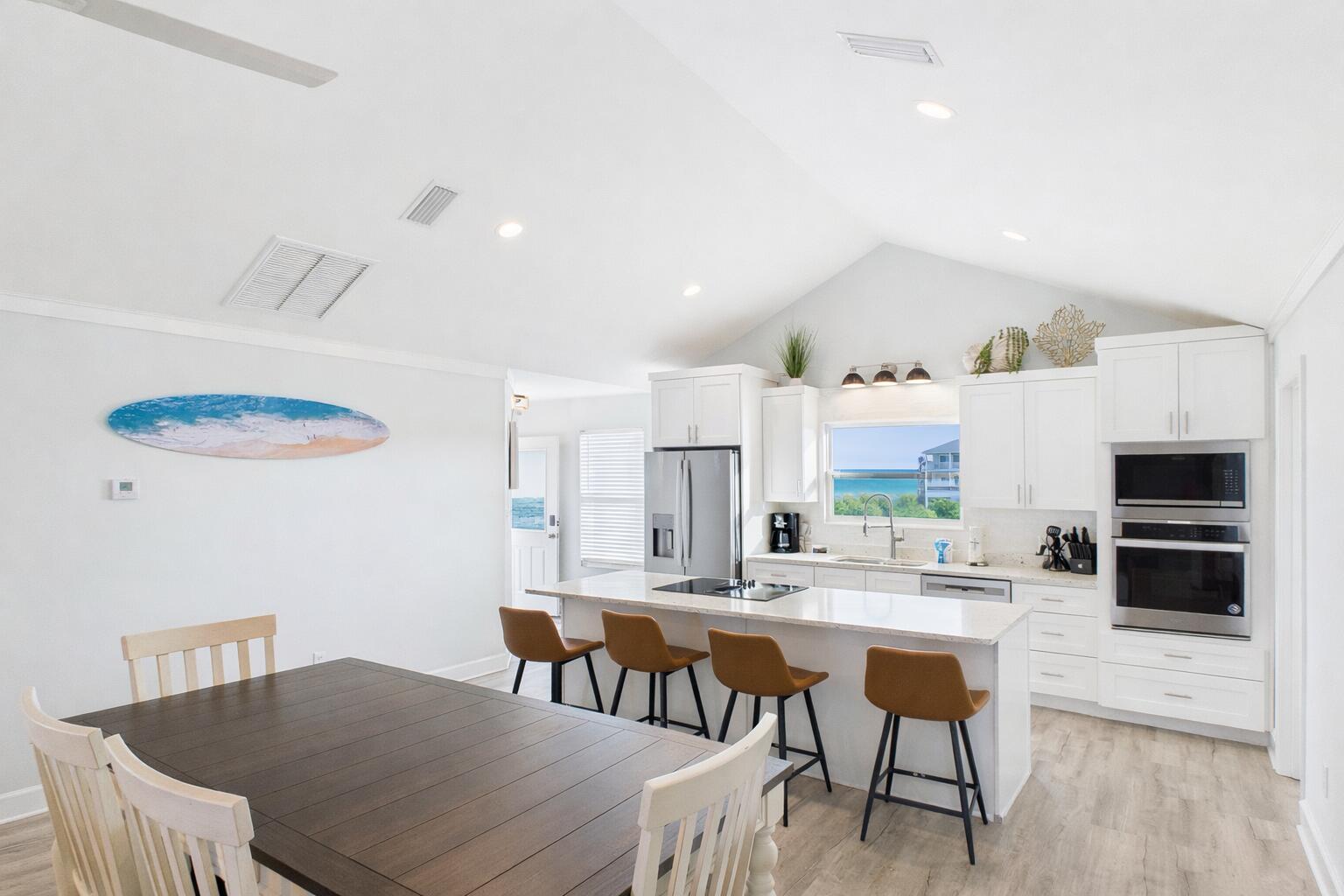 5191 Clipper Way Port St. Joe, FL 32456 - Photo 5 of 23 a kitchen with stainless steel appliances a dining table chairs and a refrigerator