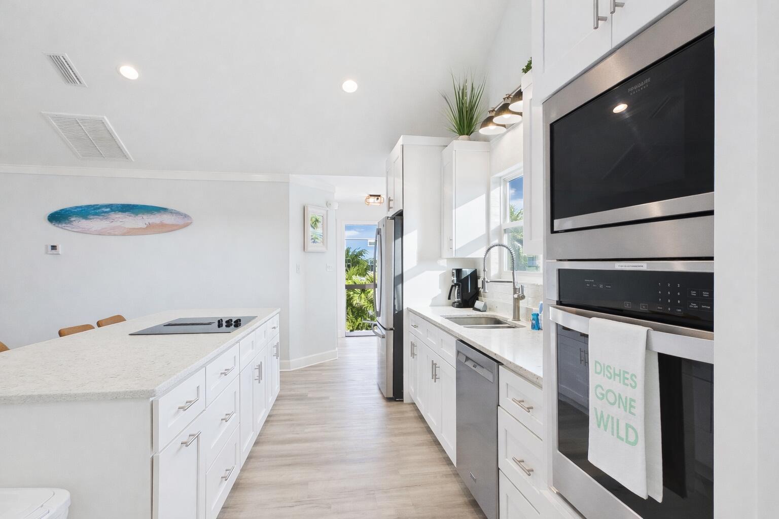 5191 Clipper Way Port St. Joe, FL 32456 - Photo 9 of 23 a kitchen with stainless steel appliances kitchen island granite countertop a stove a sink and a microwave