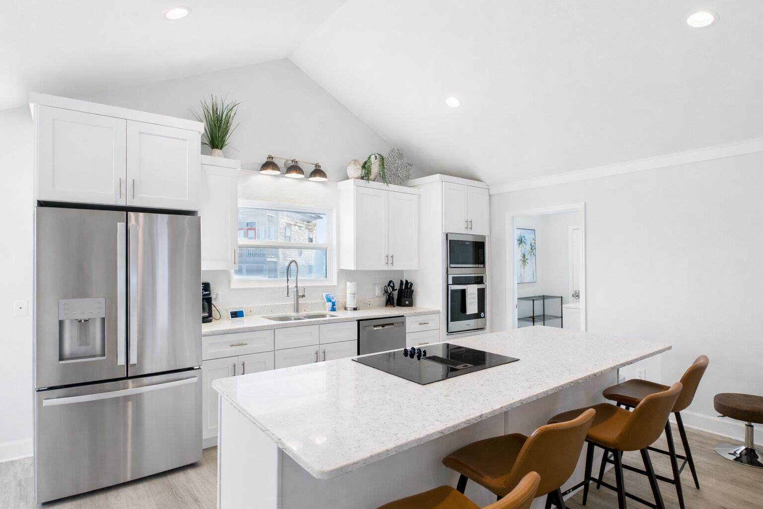 5191 Clipper Way Port St. Joe, FL 32456 - Photo 10 of 23 a kitchen with stainless steel appliances a refrigerator a sink a stove and white cabinets