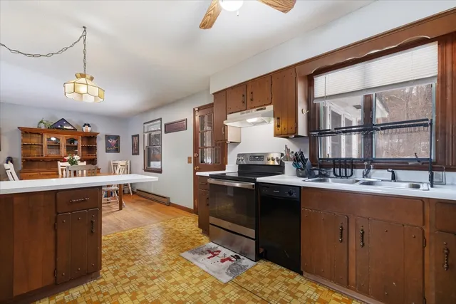 a kitchen with sink stove and cabinets