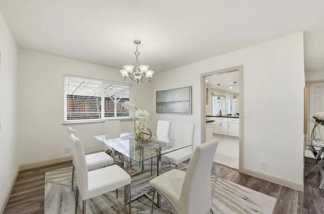 a view of a dining room with furniture and chandelier