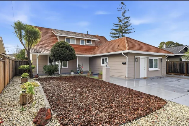 a front view of a house with a garden