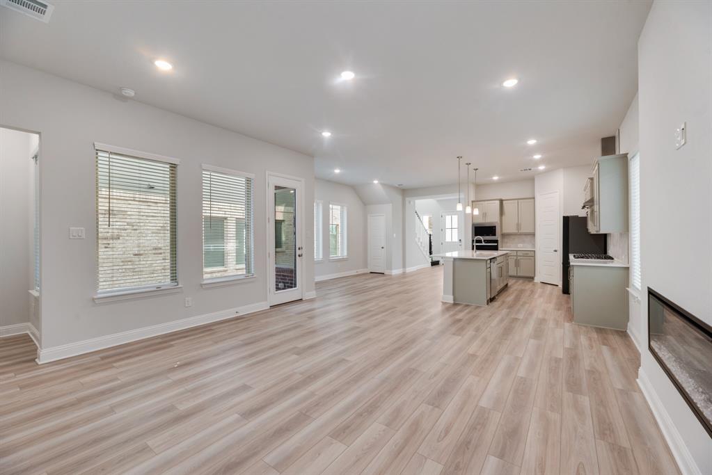 7009 Sunset Boulevard Rowlett, TX 75088 - Photo 17 of 35 a view of kitchen with refrigerator microwave and wooden floor