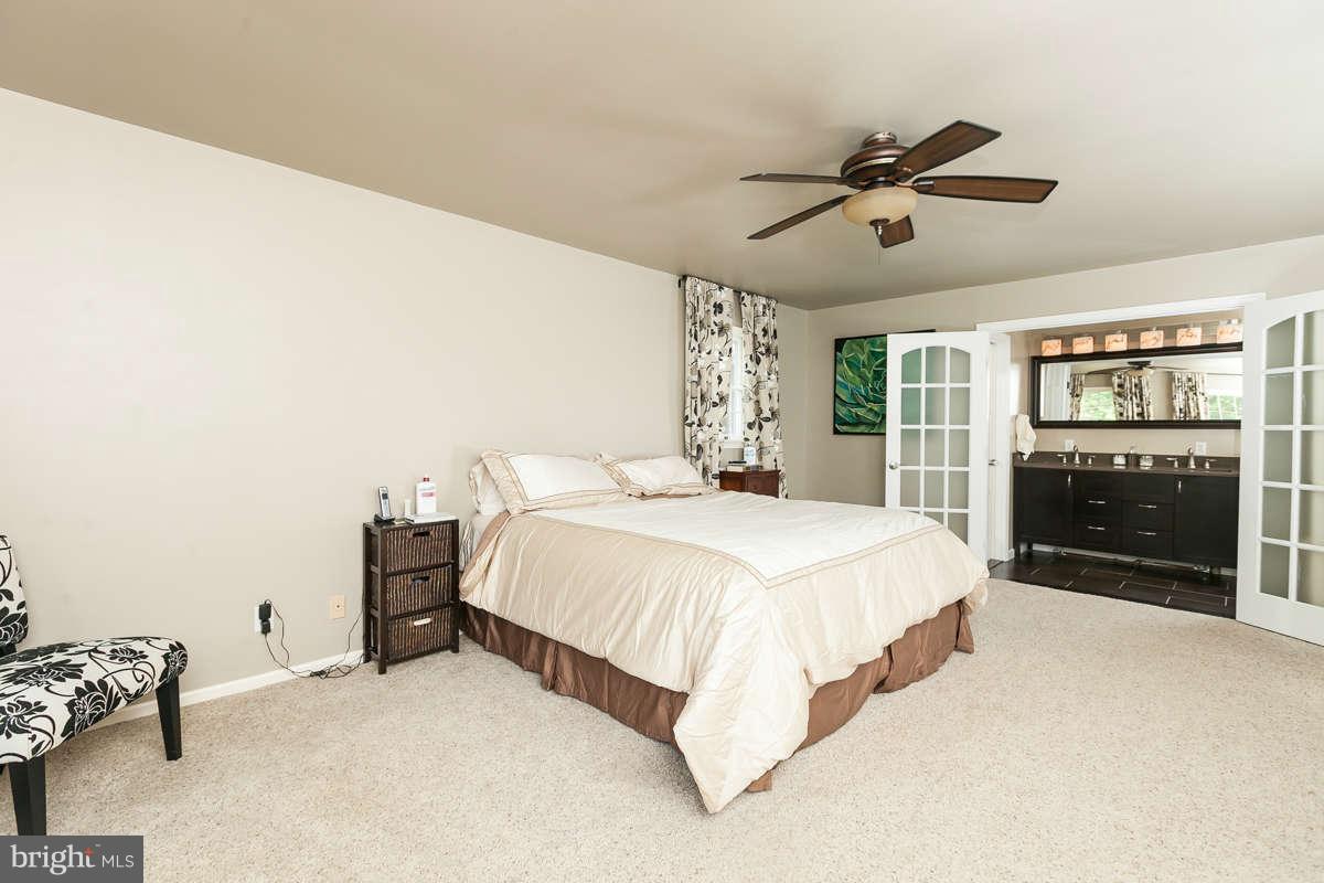 1769 Florence Road Mount Airy, MD 21771 - Photo 17 of 30 a spacious bedroom with a bed and a view of kitchen
