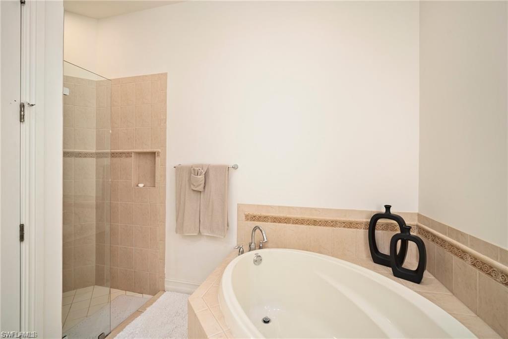 8519 Chase Preserve Drive Naples, FL 34113 - Photo 14 of 29 a bathroom with a white bath tub and shower