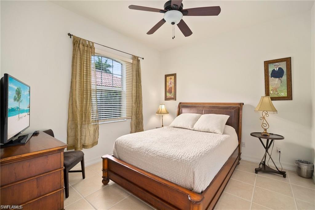 8519 Chase Preserve Drive Naples, FL 34113 - Photo 18 of 29 a bedroom with a bed and a flat screen tv