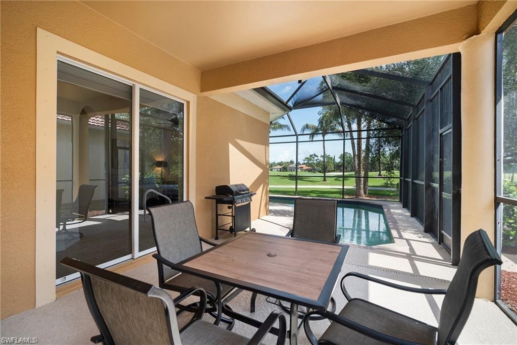 8519 Chase Preserve Drive Naples, FL 34113 - Photo 19 of 29 a view of a patio with a table chairs and a backyard