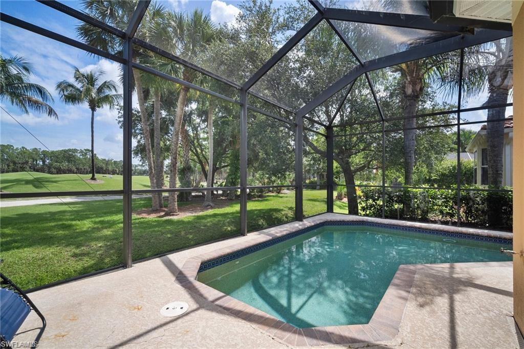 8519 Chase Preserve Drive Naples, FL 34113 - Photo 22 of 29 a view of a backyard with a garden and trees