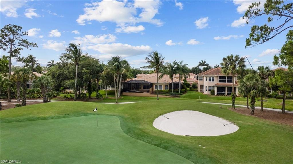 8519 Chase Preserve Drive Naples, FL 34113 - Photo 28 of 29 a view of a big house with a big yard and a large trees