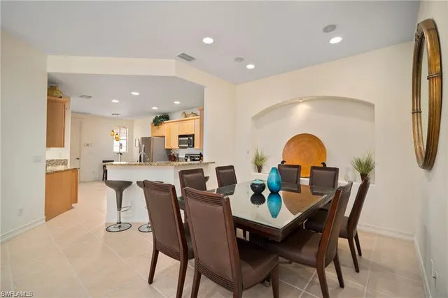 a dining room with furniture and a wooden floor