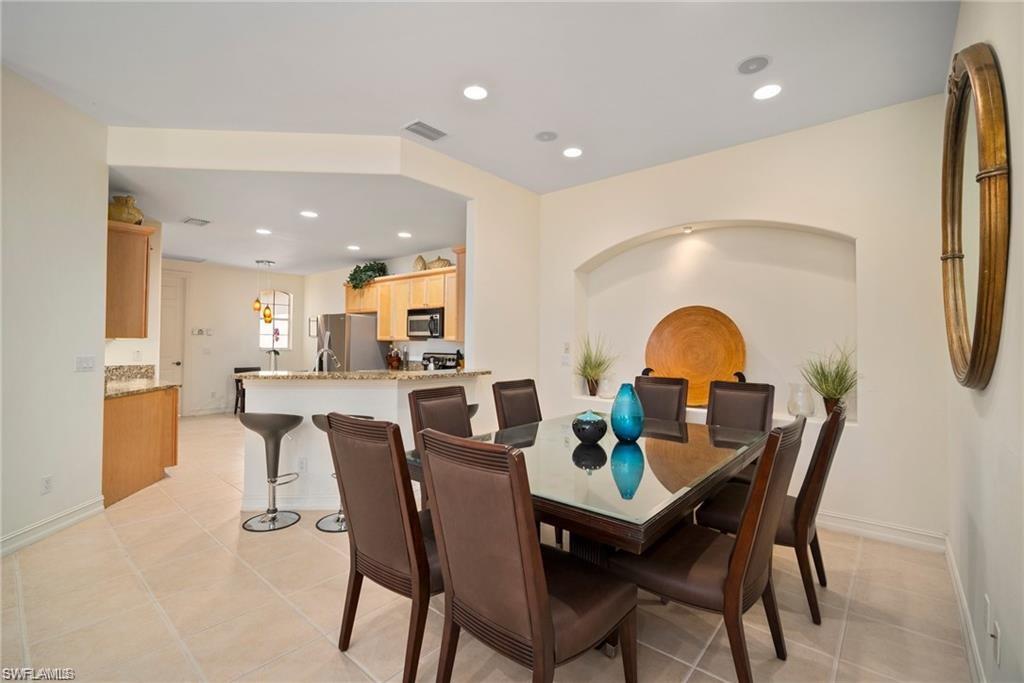 8519 Chase Preserve Drive Naples, FL 34113 - Photo 4 of 29 a dining room with furniture and a wooden floor
