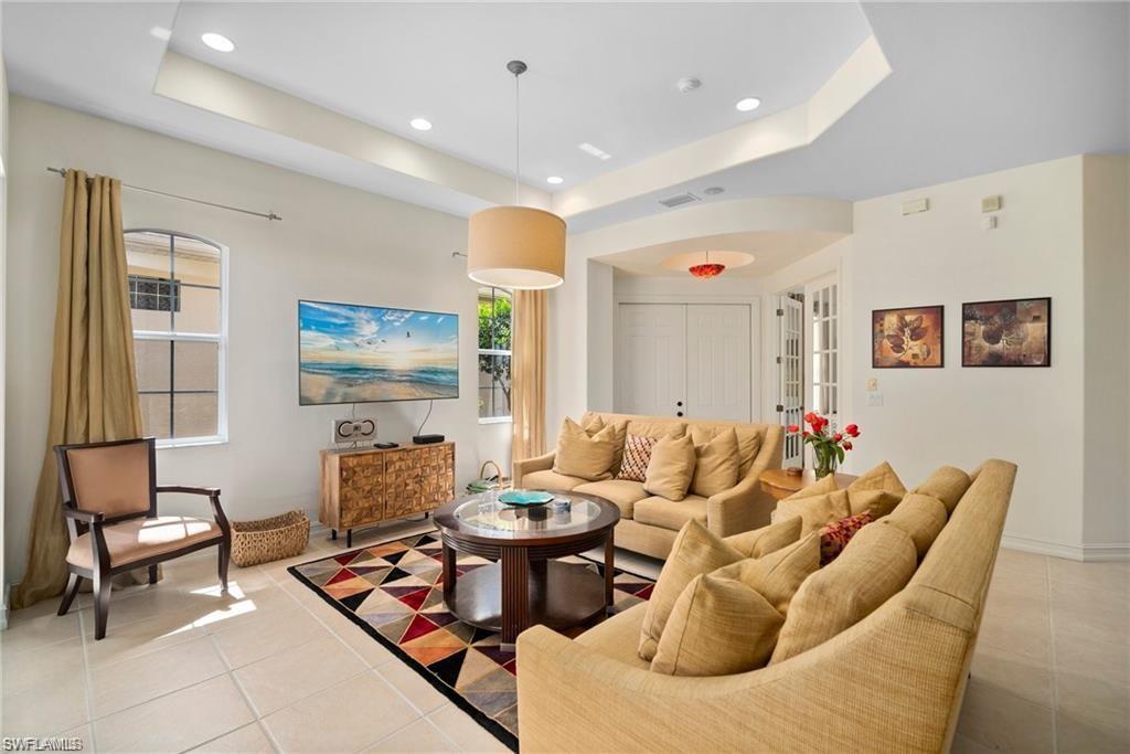 8519 Chase Preserve Drive Naples, FL 34113 - Photo 5 of 29 a living room with furniture and a flat screen tv