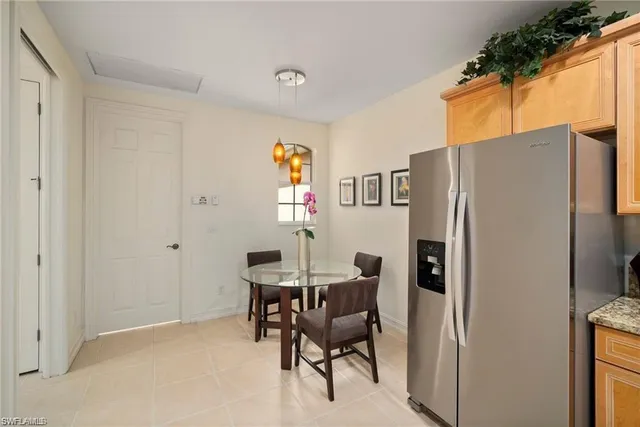 a kitchen with stainless steel appliances a refrigerator and a table