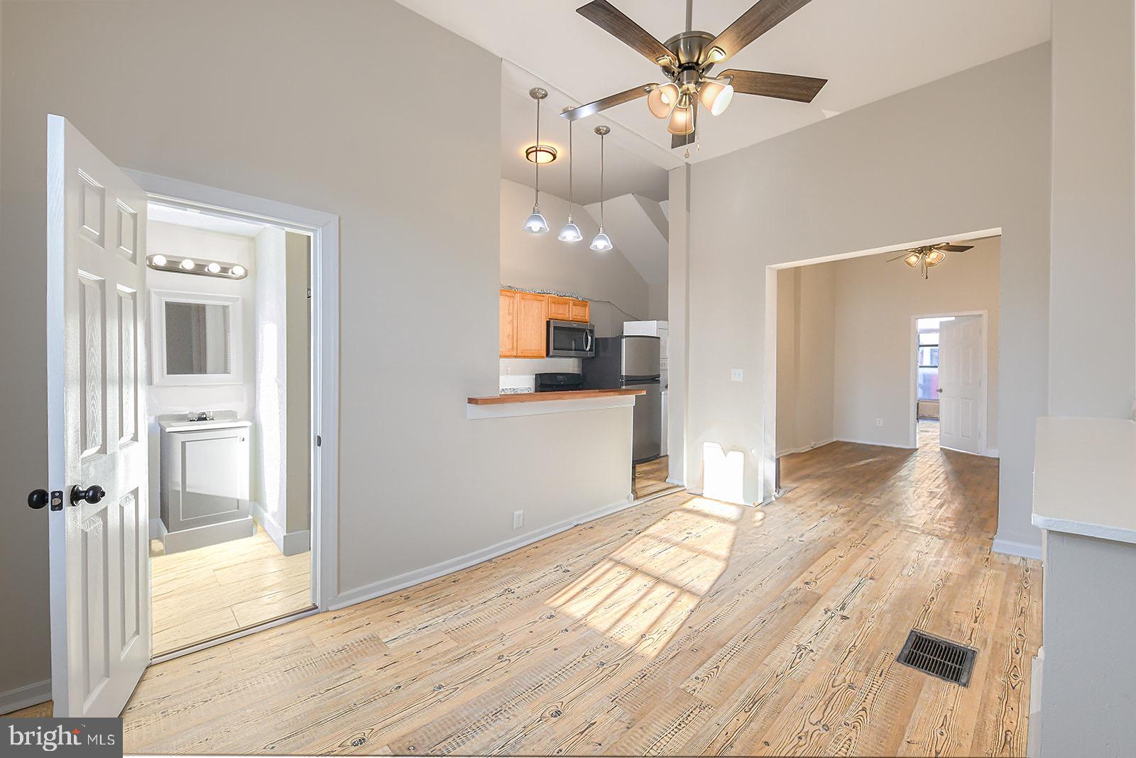 1908 McCulloh Street, Unit 1 Baltimore, MD 21217 - Photo 1 of 24 a view of a livingroom with a chandelier fan and wooden floor