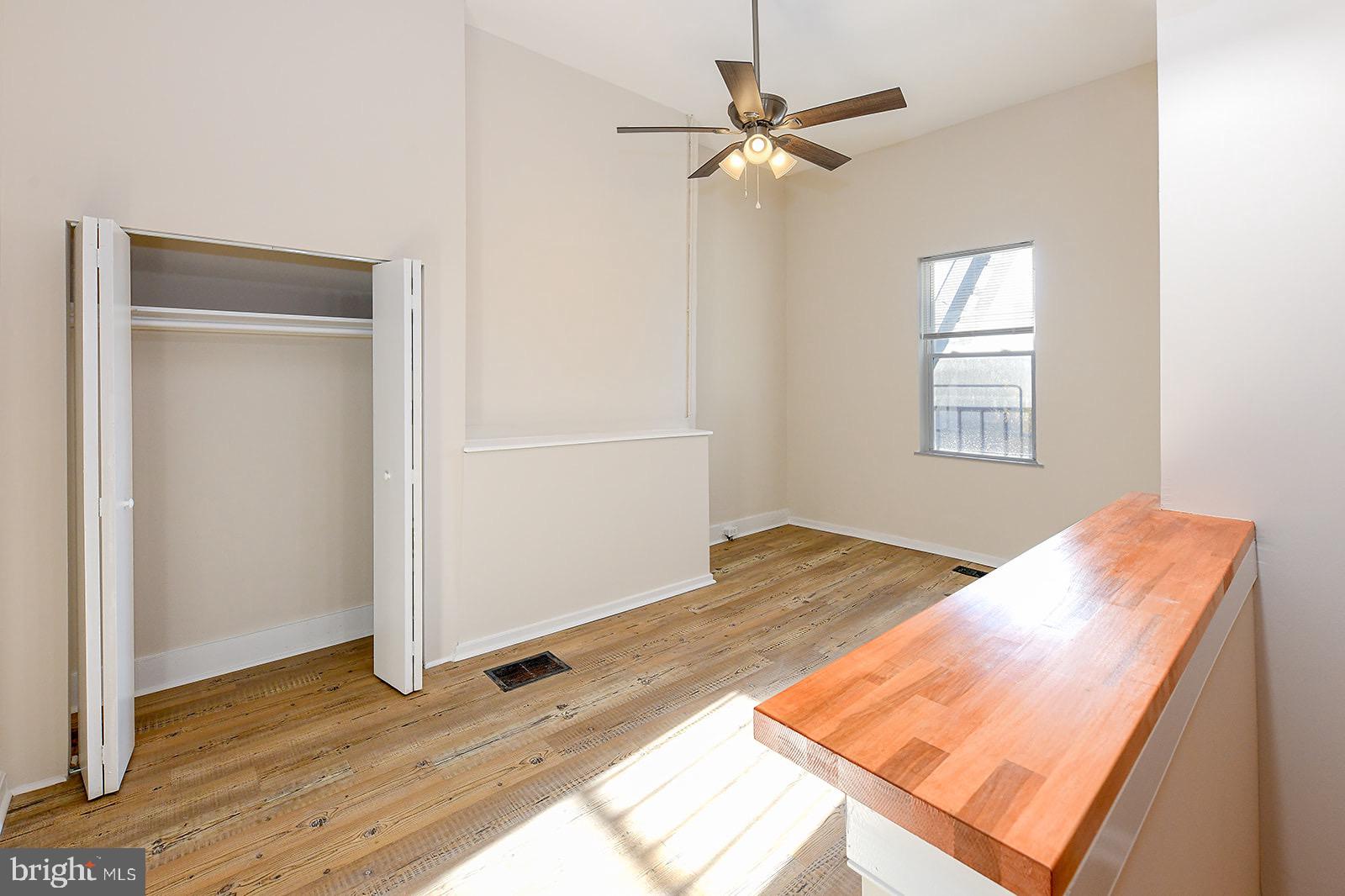 1908 McCulloh Street, Unit 1 Baltimore, MD 21217 - Photo 11 of 24 a view of a bedroom with wooden floor and closet