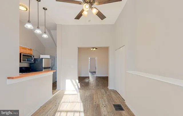 a view of a house with a sink and wooden floor