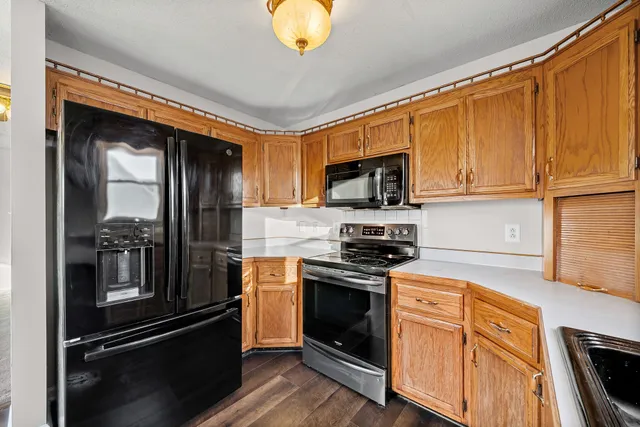 a kitchen with granite countertop stainless steel appliances and wooden cabinets
