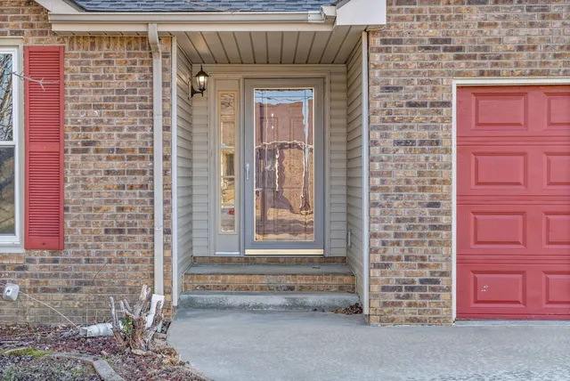 a front view of a house with a red door
