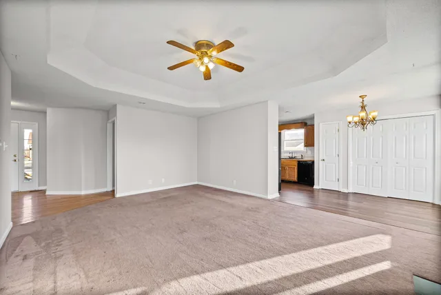 an empty room with windows and cabinet