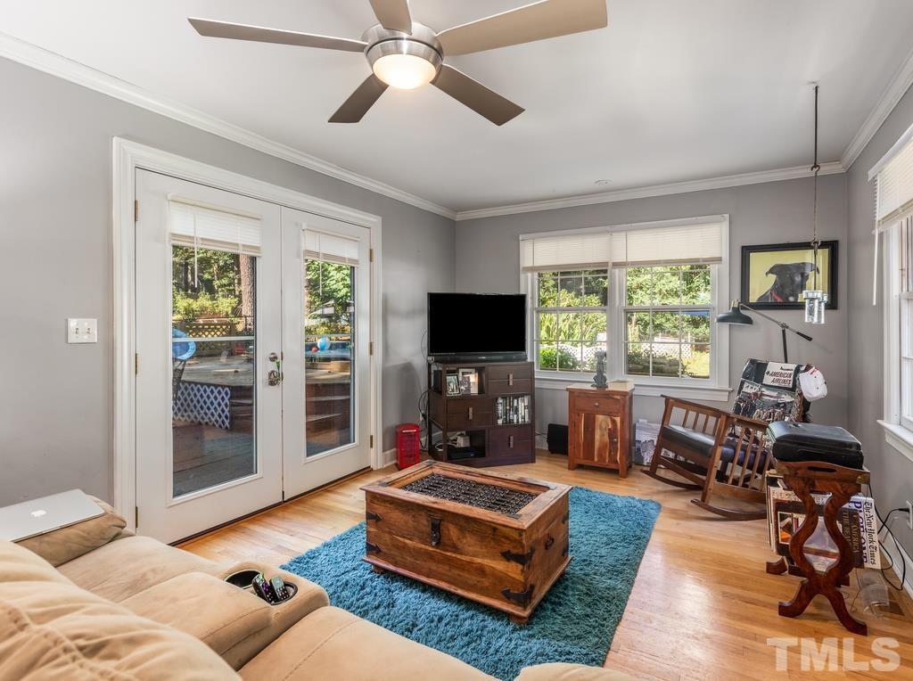 5808 Heatherbrook Circle Raleigh, NC 27612 - Photo 13 of 26 a living room with furniture a flat screen tv and a large window