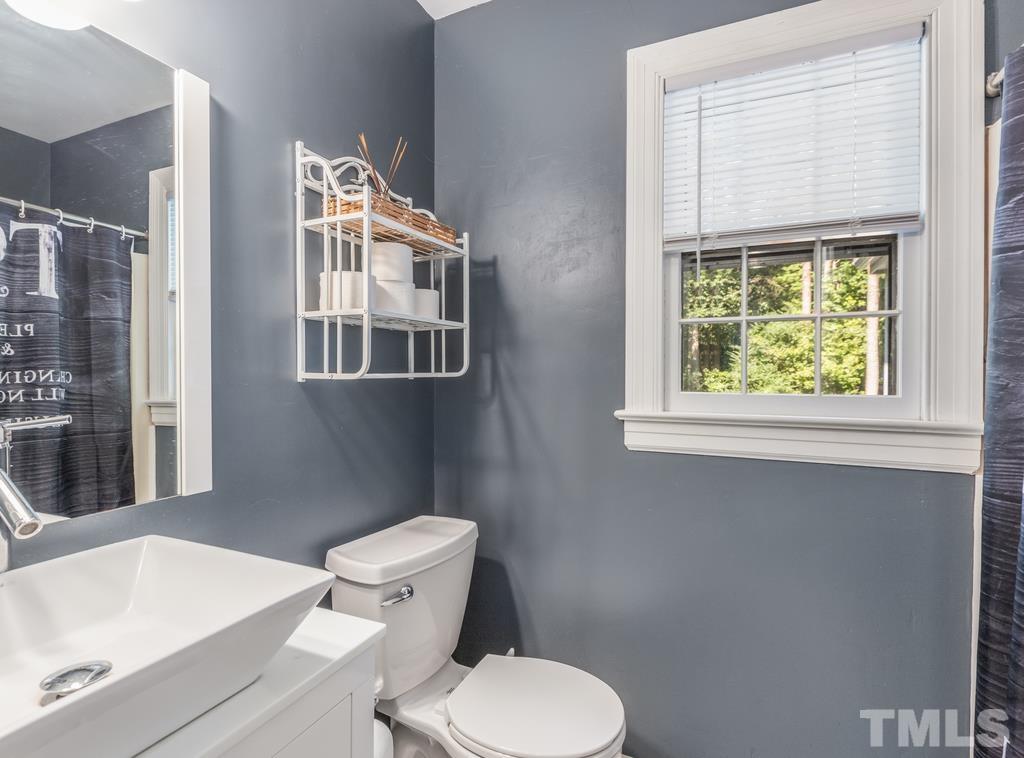 5808 Heatherbrook Circle Raleigh, NC 27612 - Photo 15 of 26 a white toilet sitting next to a bathroom sink