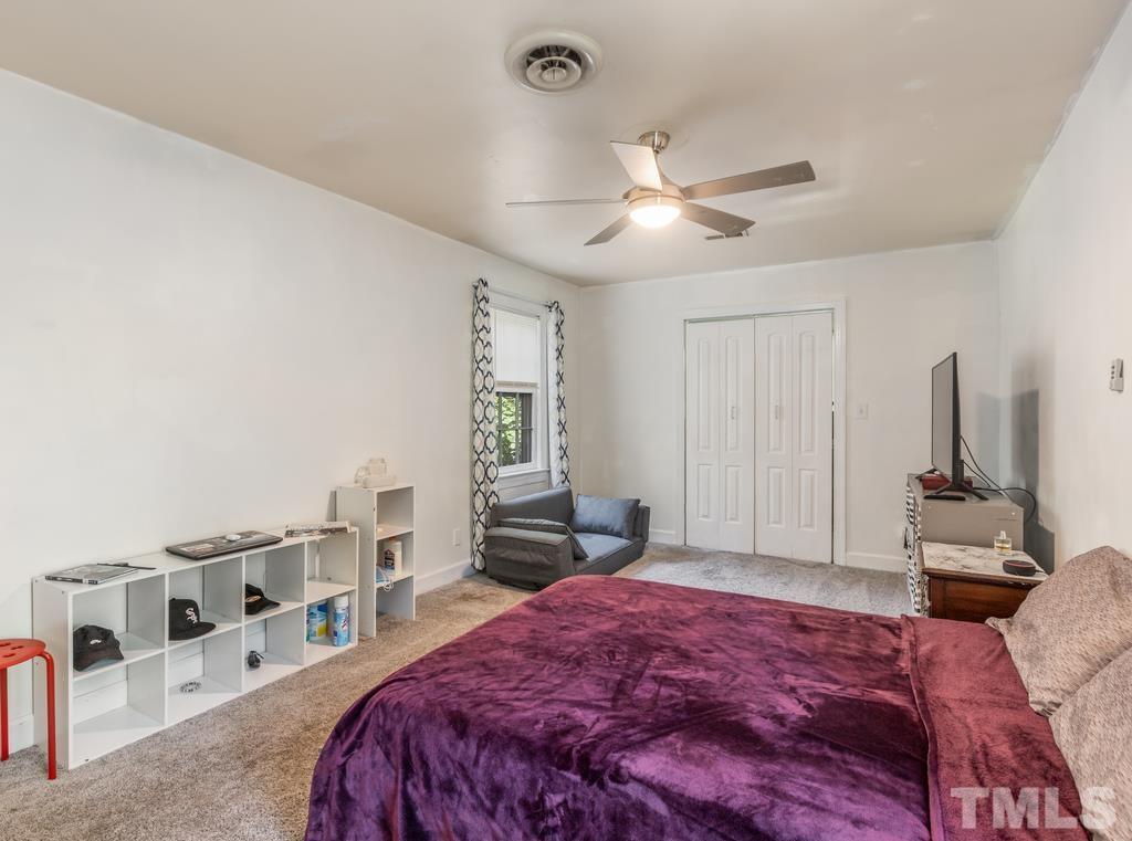 5808 Heatherbrook Circle Raleigh, NC 27612 - Photo 17 of 26 a bedroom with a large bed and a window