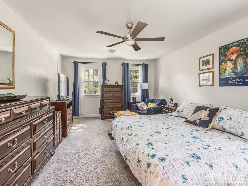 5808 Heatherbrook Circle Raleigh, NC 27612 - Photo 21 of 26 a bedroom with a bed and wooden floor