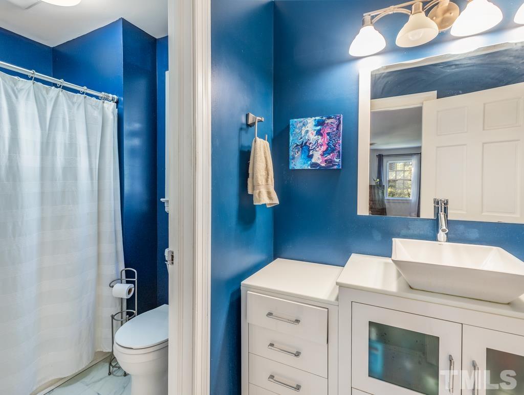 5808 Heatherbrook Circle Raleigh, NC 27612 - Photo 22 of 26 a bathroom with a sink and a mirror