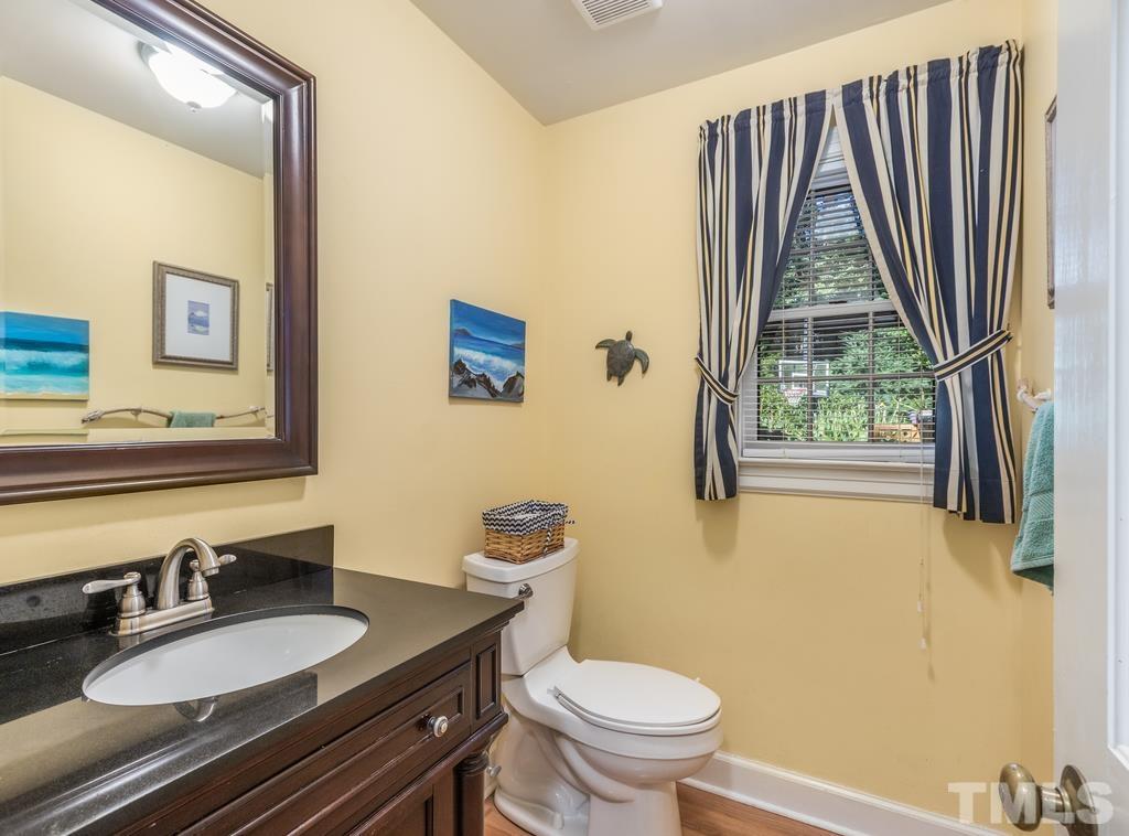 5808 Heatherbrook Circle Raleigh, NC 27612 - Photo 10 of 26 a bathroom with a granite countertop toilet sink and mirror