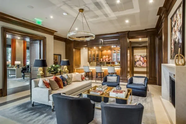 a living room with furniture and large windows