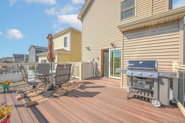 a view of a balcony with wooden floor and city view