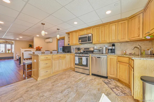 a kitchen with white cabinets and appliances