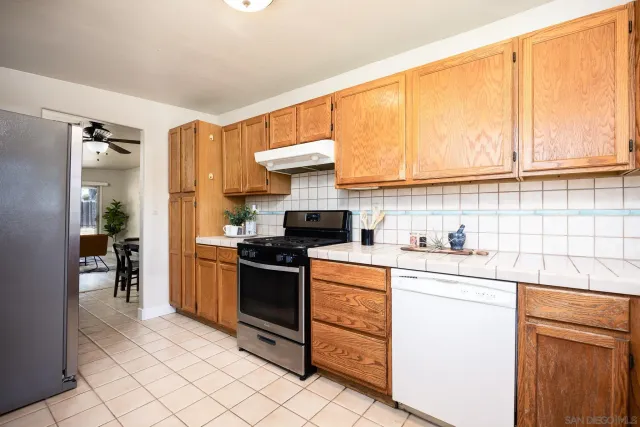 a kitchen with stainless steel appliances a refrigerator and a stove