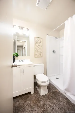 an empty room with closet and fan