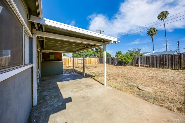 a view of a hallway with wooden floor and windows