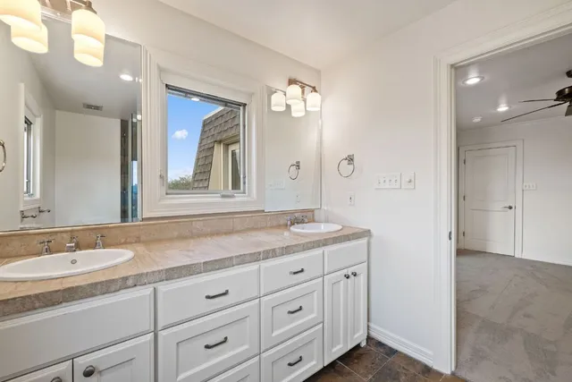 a bathroom with a granite countertop sink mirror and double