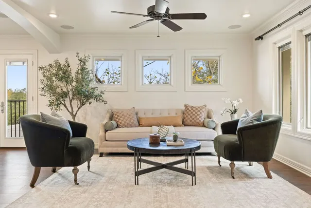 a living room with furniture a rug and a window