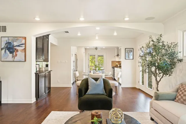 a living room with furniture window and wooden floor