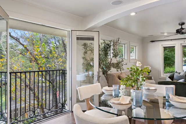 a dining room with furniture window and wooden floor