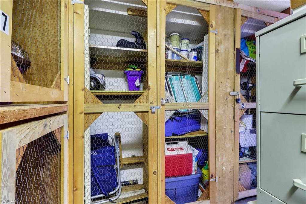 300 Valley Stream Drive, Unit A4 Naples, FL 34113 - Photo 14 of 25 a view of walk in closet with clothes and shoes