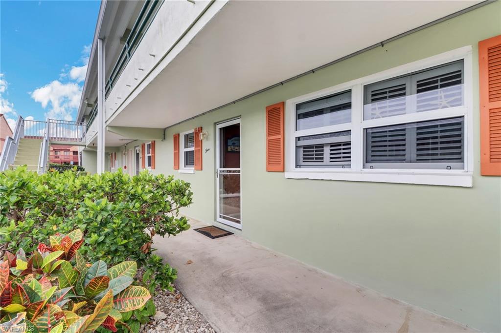 300 Valley Stream Drive, Unit A4 Naples, FL 34113 - Photo 2 of 25 a front view of a house with a yard