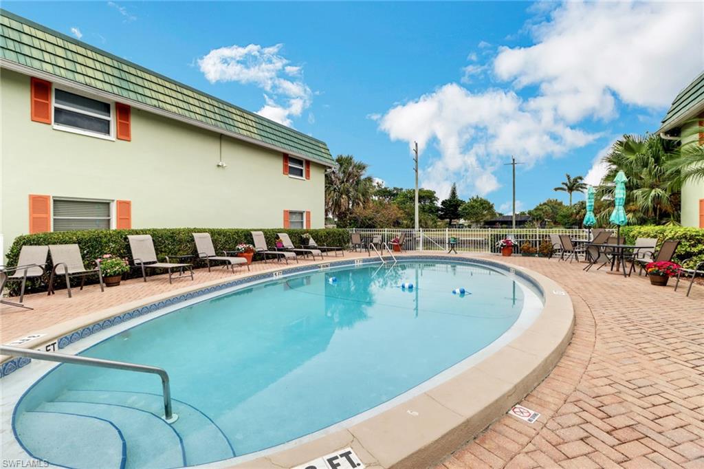300 Valley Stream Drive, Unit A4 Naples, FL 34113 - Photo 23 of 25 a view of a swimming pool with outdoor seating
